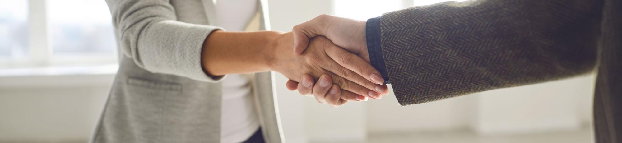 two ucla team members shake hands 